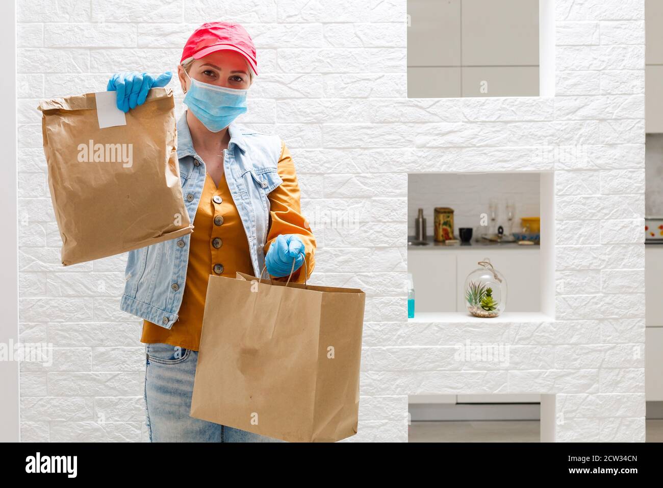 masked delivery woman delivers food during virus outbreak, coronavirus ...