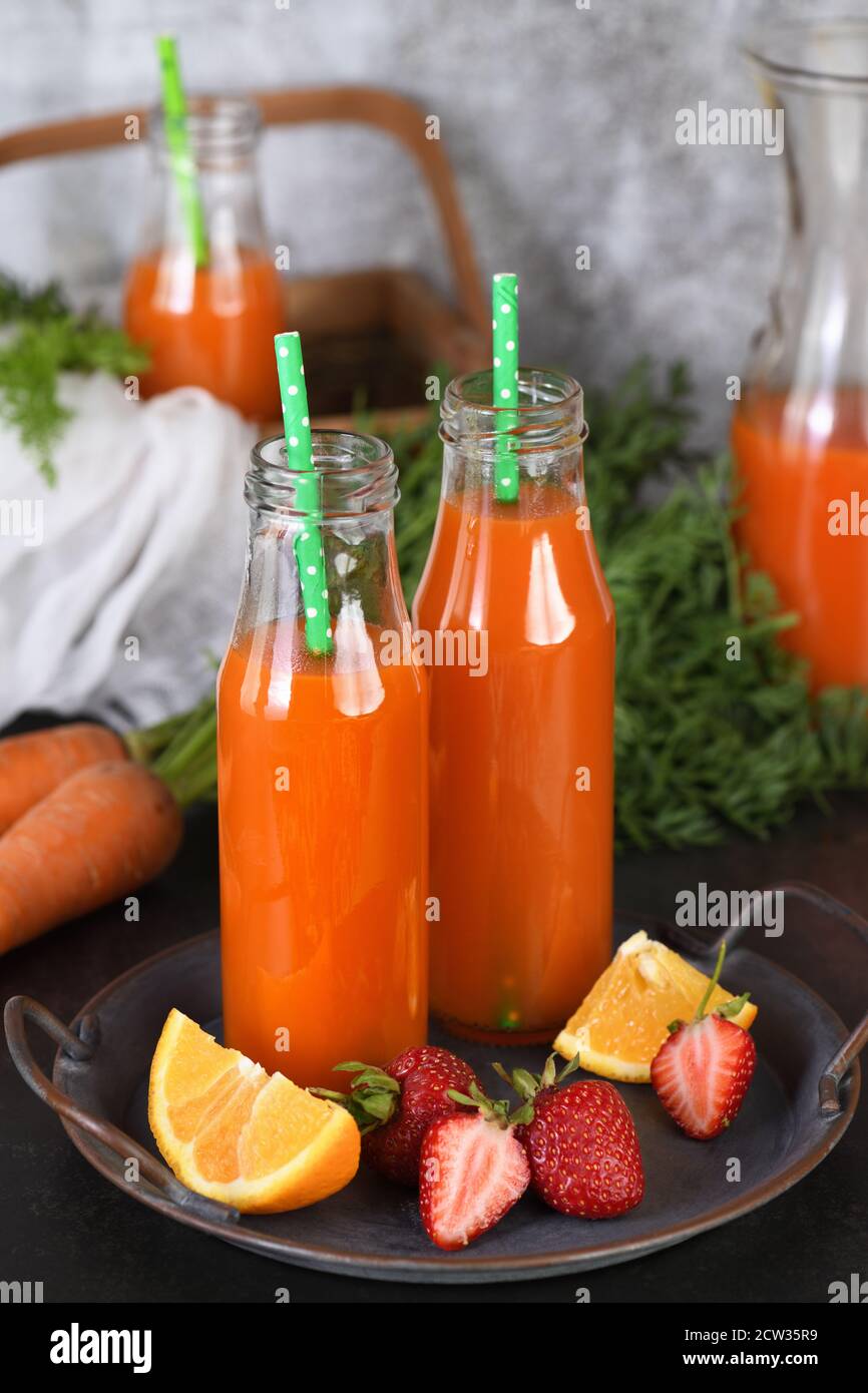 Detox drink. Freshly made Carrot Strawberry Orange Juice. For those who monitor their health Stock Photo