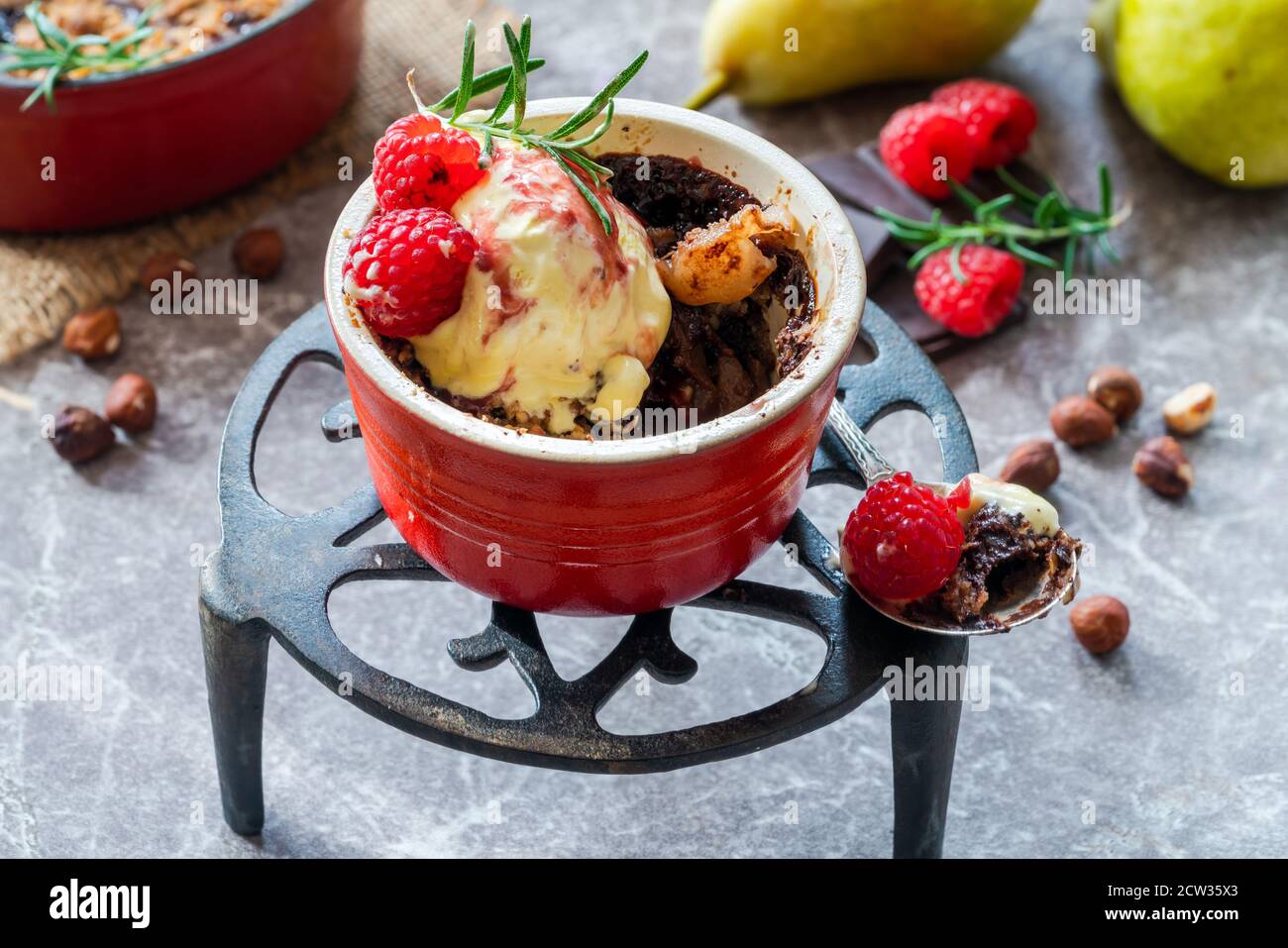 Pear crumble dessert with chocolate, hazelnuts, icecream and raspberry ...