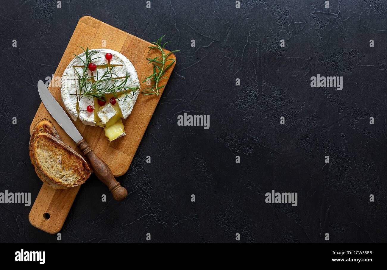 Oven baked Camembert cheese with honey, figs, and fresh bread Stock