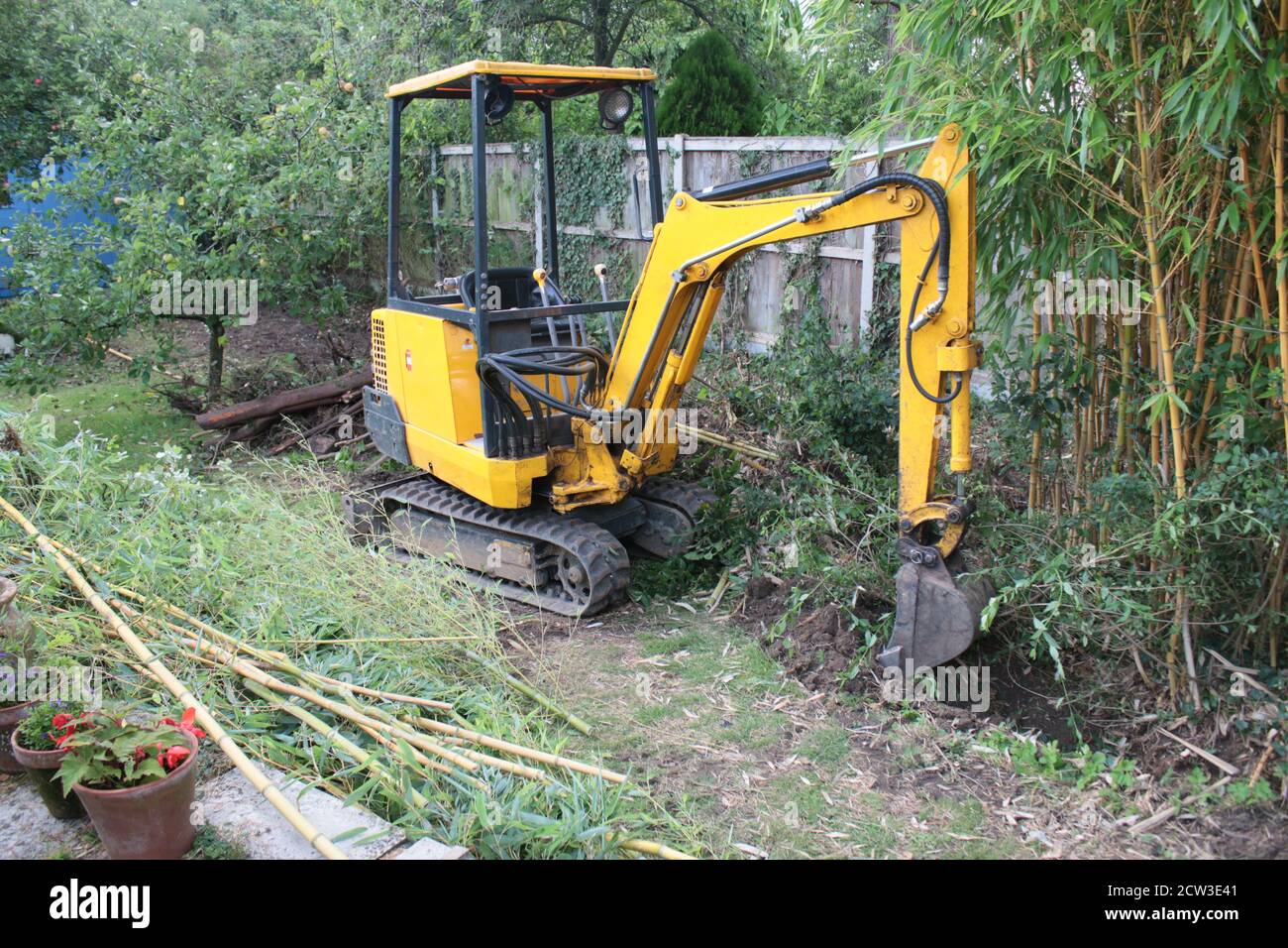 Yellow digger heavy motor machinery with digging arm moving earth, re