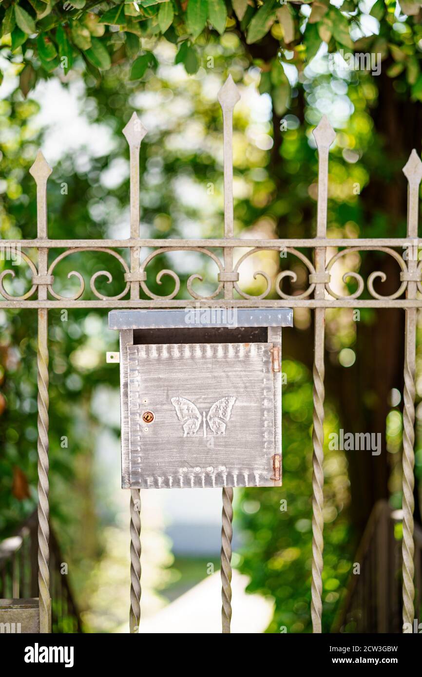 Metal mailbox with butterfly pattern on the gate. Stock Photo