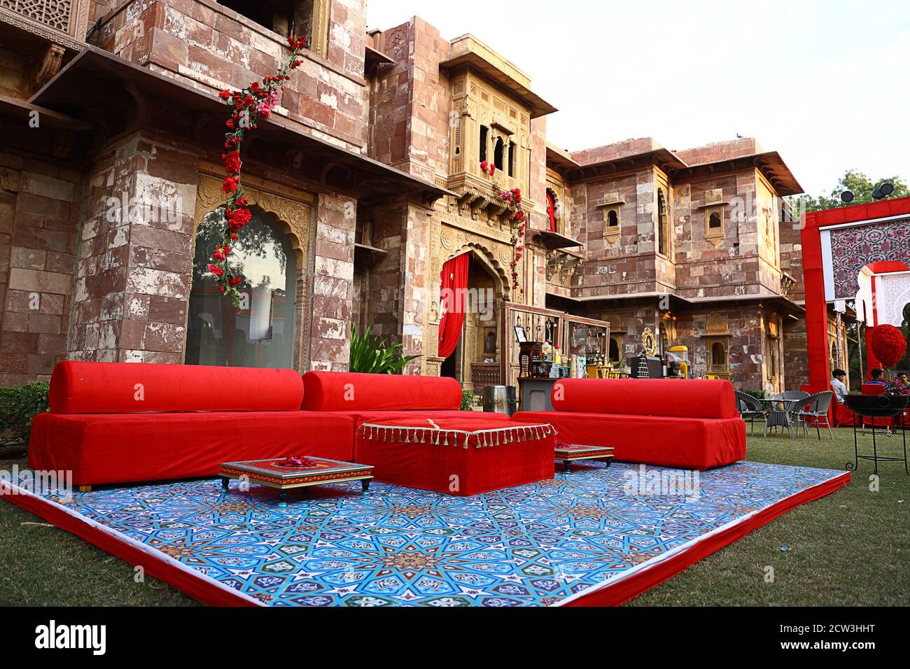 Jodhpur, Rajasthan, India, August 20th, 2020: luxury wedding destination decorated with red sofas or couches and flowers in indian palace backyard, we Stock Photo