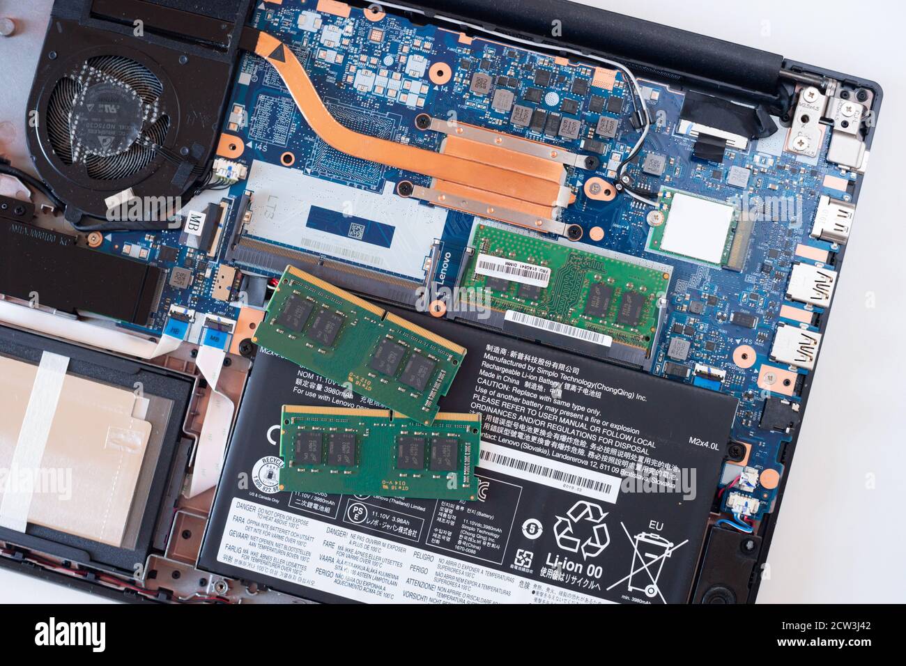 Image depicting an open laptop computer with memory or RAM sticks ready