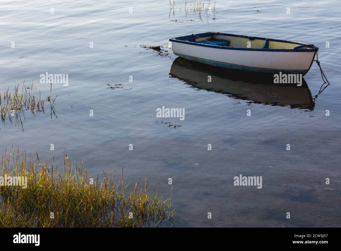 An old wooden boat moored in a calm marina Stock Photo - Alamy