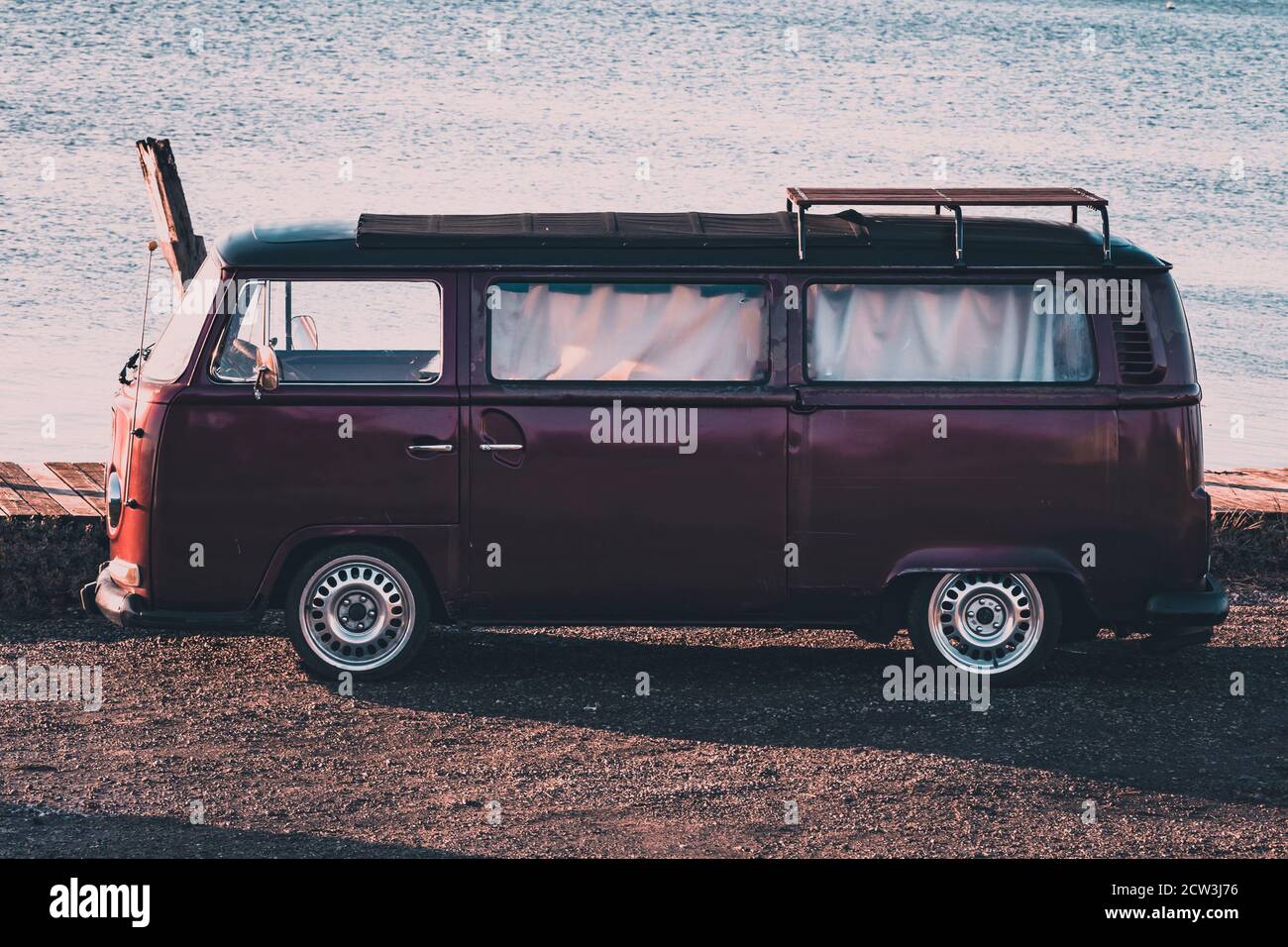 A vintage camper van parked near the sea at sunset Stock Photo - Alamy
