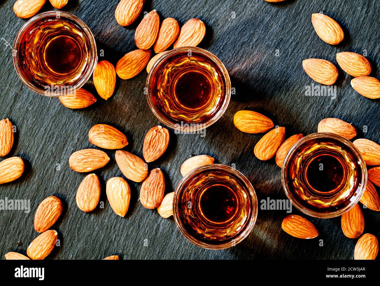 Amaretto almond liqueur with a dark background, top view Stock Photo
