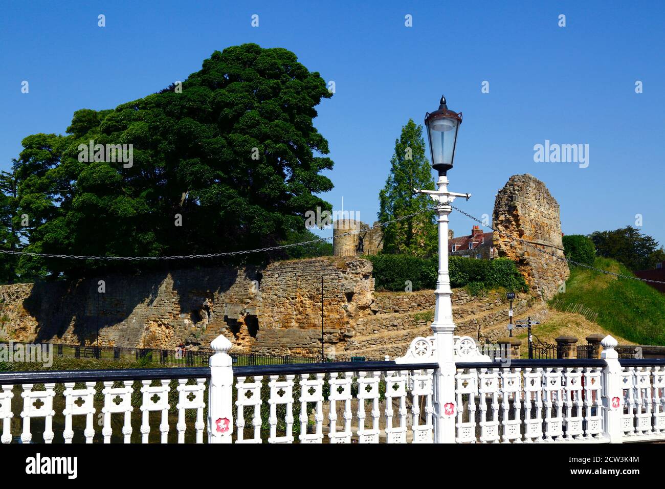 Walls of Tonbridge Castle and railings of bridge carrying High Street