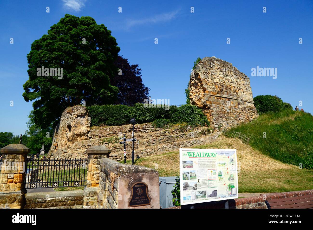 Wealdway long distance footpath information sign and part of outer walls of Tonbridge Castle, High Street, Tonbridge, Kent , England Stock Photo