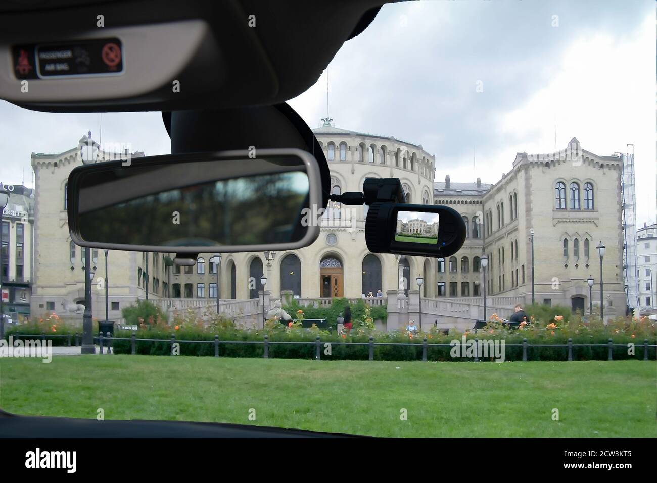 Looking through a dashcam car camera installed on a windshield with view of the facade of the Norwegian Parliament in Oslo, Norway Stock Photo