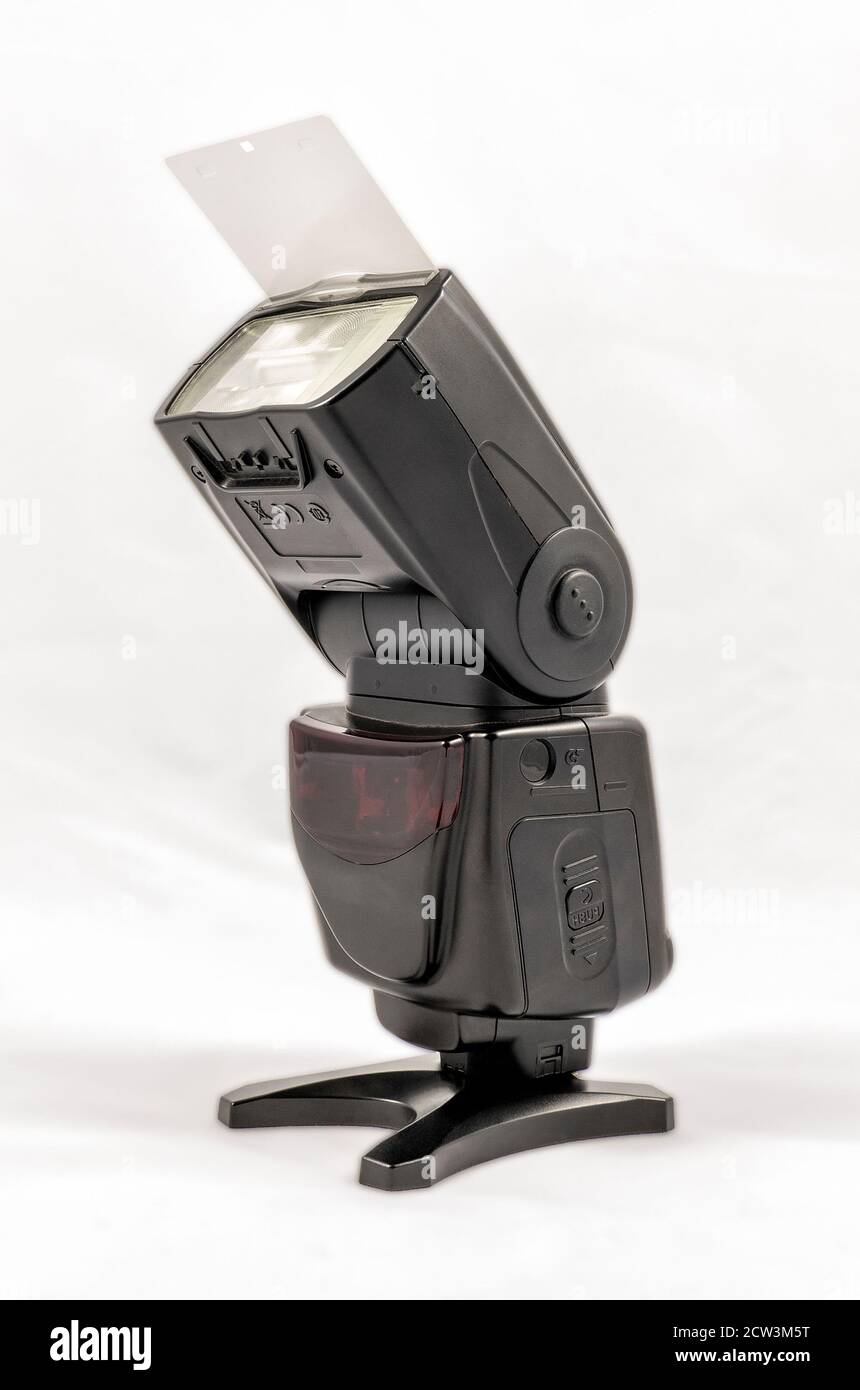 Oblique view of a black unbranded external flash unit for DSLR camera with  bounce card extended Stock Photo - Alamy