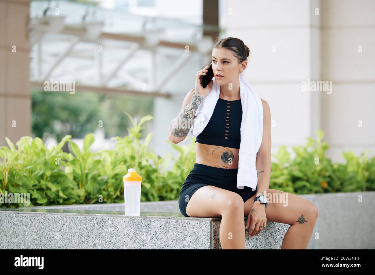 Fit woman talking on phone Stock Photo