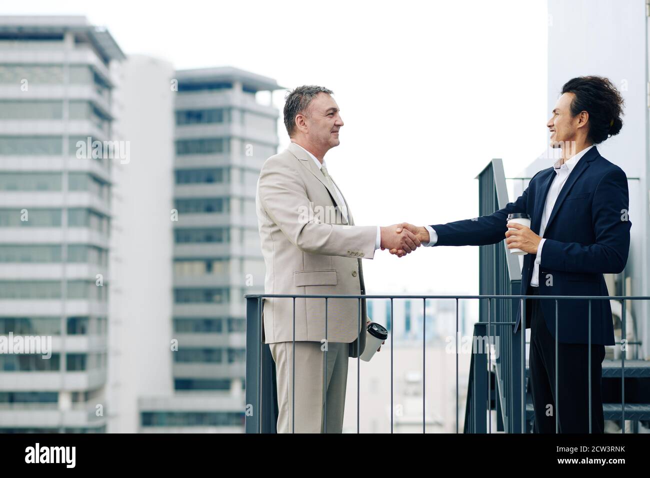 Positive entrepreneurs shaking hands Stock Photo
