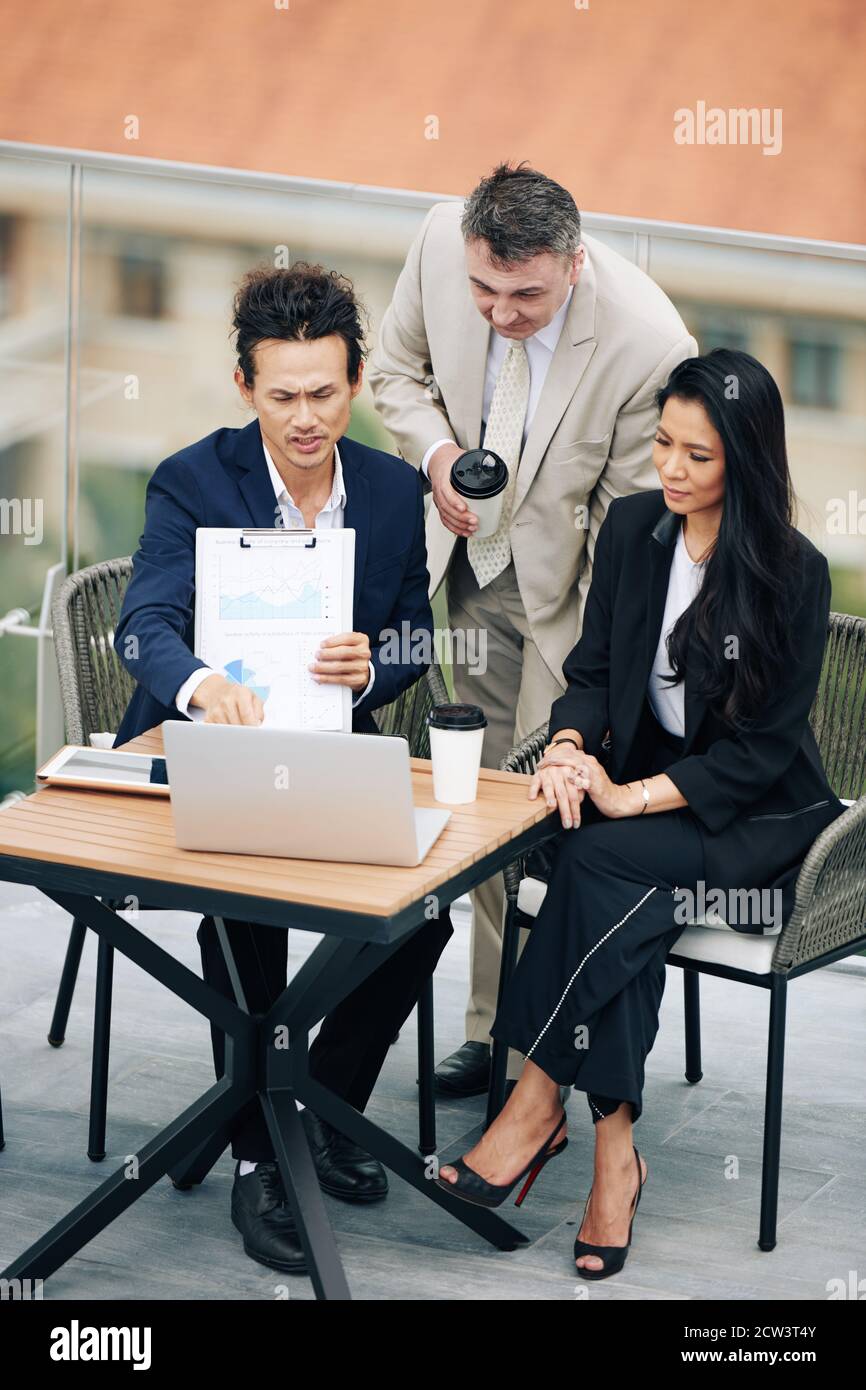 Business team discussing finance data Stock Photo