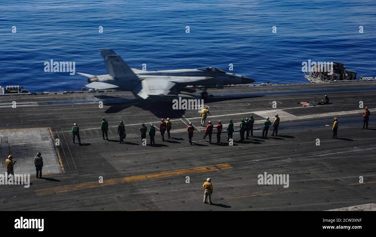 Capt. Pat “Fin” Hannifin, commanding officer of the Navy’s only forward-deployed aircraft carrier USS Ronald Reagan (CVN 76), pilots an F/A 18E Super Hornet, attached to the Royal Maces of Strike Fighter Squadron (VFA) 27, on the flight deck. Ronald Reagan, the flagship of Carrier Strike Group 5, provides a combat-ready force that protects and defends the United States, as well as the collective maritime interests of its allies and partners in the Indo-Pacific region. (U.S. Navy photo by Mass Communication Specialist Seaman Askia Collins) Stock Photo