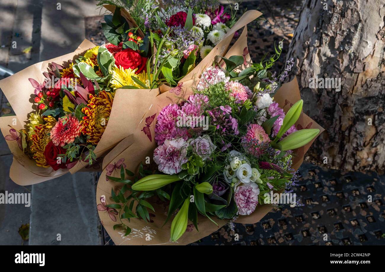 Beautiful boquet of colourful flowers warpped in brown paper Stock Photo