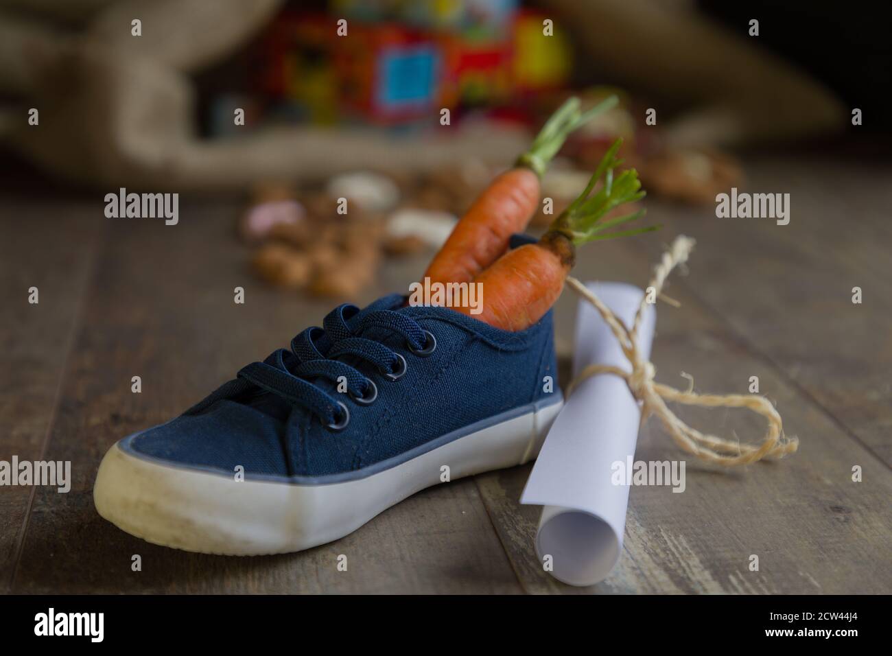 A kid places his shoe with carrots for Amerigo, the horse of Sinterklaas  and a drawing for Sinterklaas, Then he dreams of a bag full of presents and  c Stock Photo -