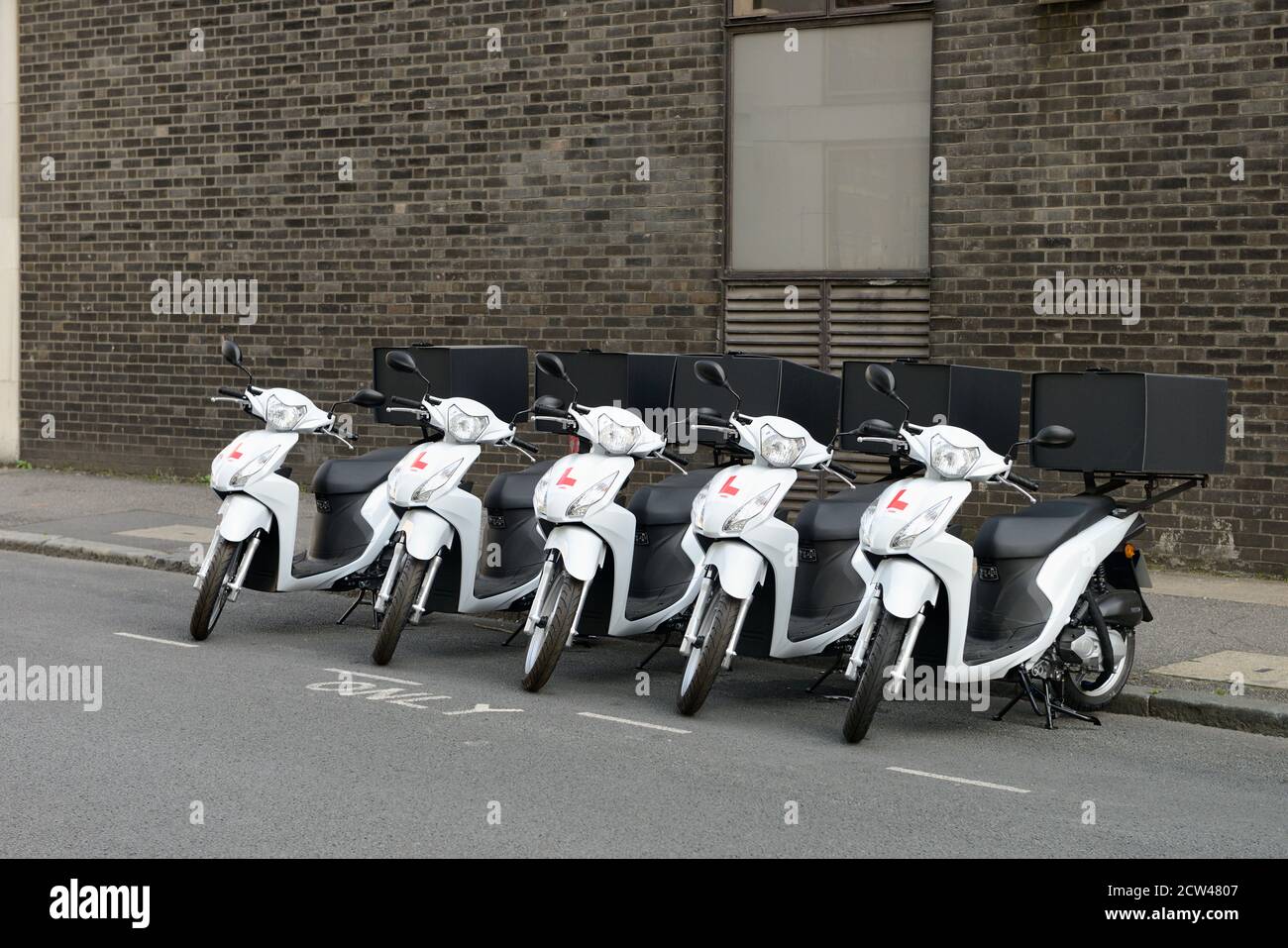 Row of white take away food delivery scooters, Wilson street, London