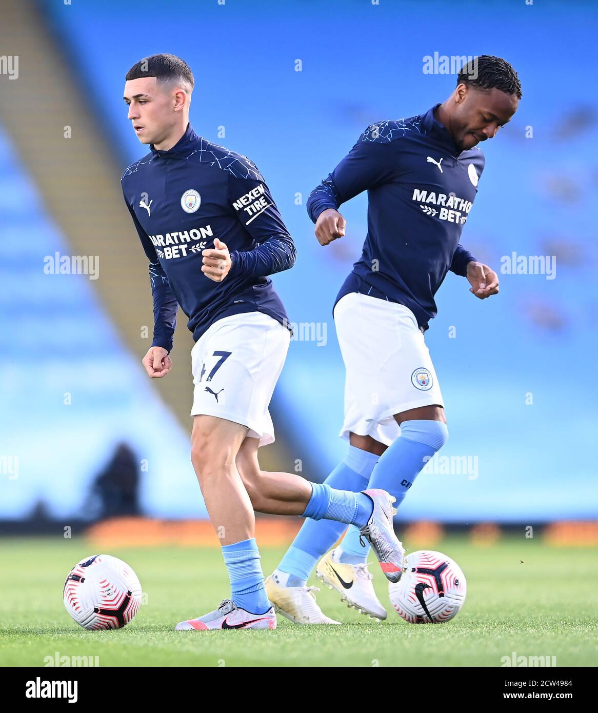 Manchester City's Phil Foden (left) and Raheem Sterling warming up before the Premier League match at the Etihad Stadium, Manchester. Stock Photo