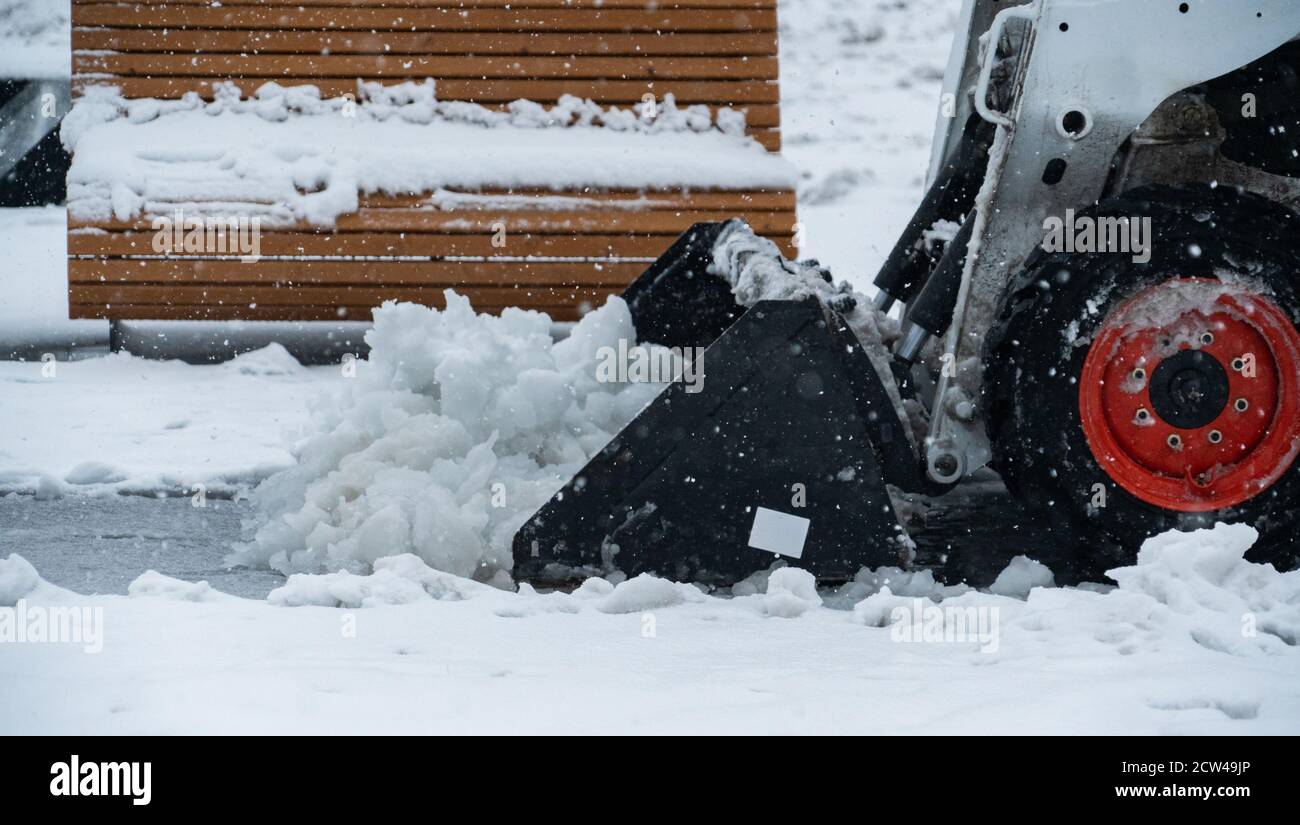 Snow blower removes snow from the sidewalk  Stock Photo