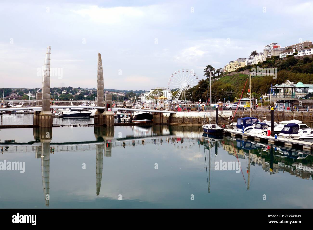 Torquay, Devon, UK.  September 15, 2020. Tourists walking over the Torbay footbridge which join the main harbour and the Inner harbour at Torquay in D Stock Photo