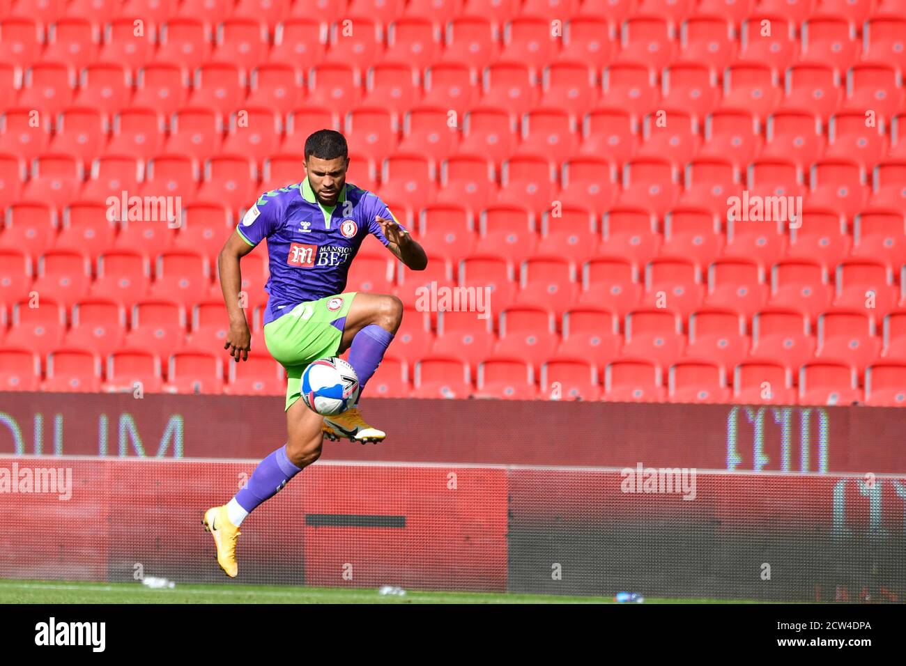 Nahki Wells (21) of Bristol City controls the ball in front of an empty stand Stock Photo