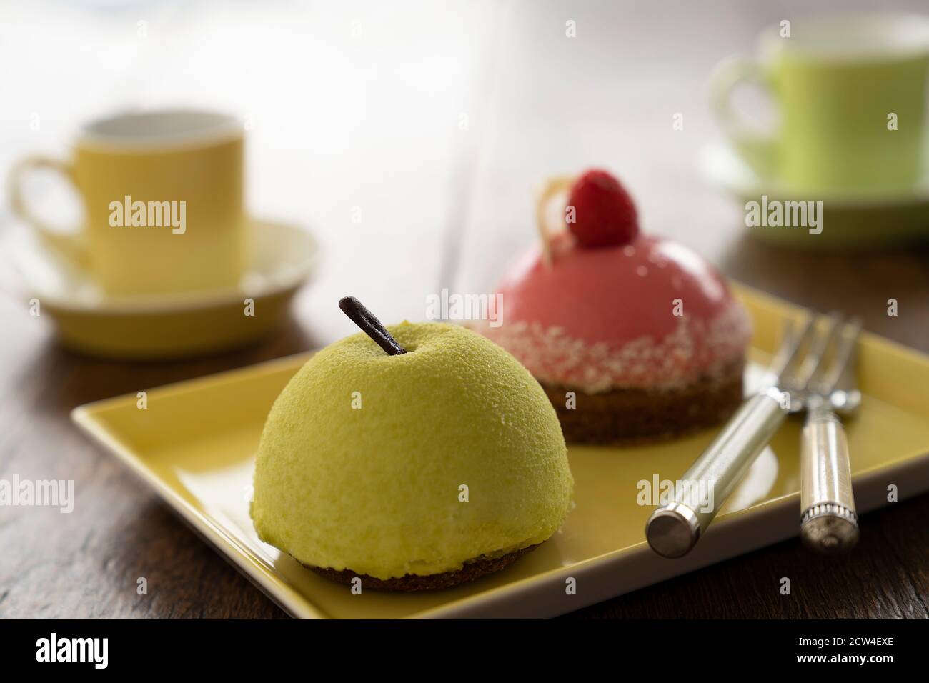 Two Small French ball shaped cakes mousse dome served on a plate with