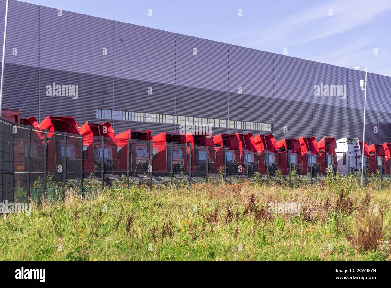 Line of parked dlivery lorries parked at Royal Mail sorting depot