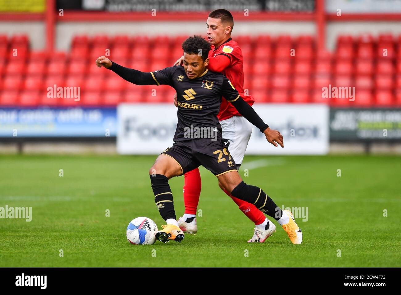 Matthew Sorinola (29) of MK Dons under pressure from Owen Dale (19) of