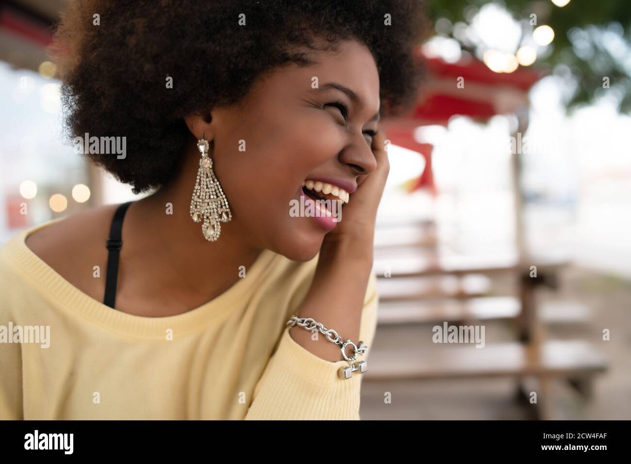 Close-up of a beautiful afro american latin woman smiling and spending nice time at the coffee shop. Stock Photo