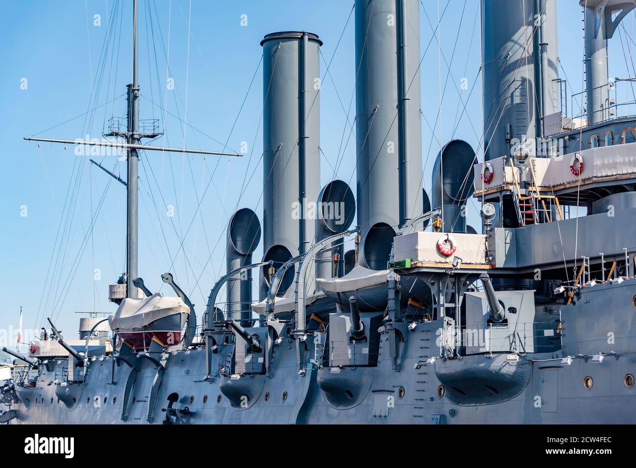 Cannons on the battle cruiser 'Aurora' built in the 19th century on the Neva river in St. Petersburg. The inscription on the lifebuoys: 'Aurora' Stock Photo