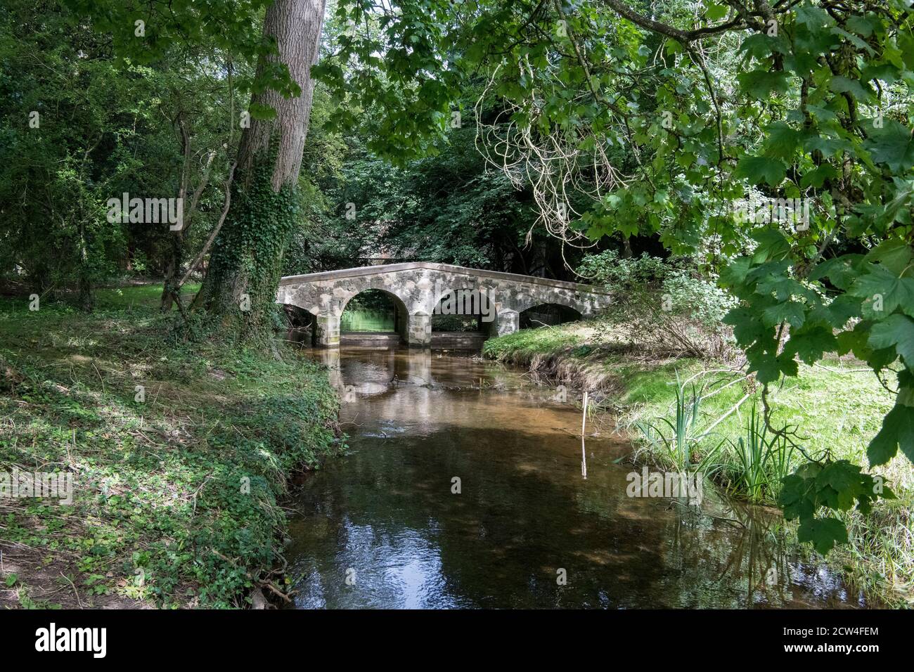 Pack Horse bridge across the River Stiffkey  Little Walsingham Norfolk Stock Photo