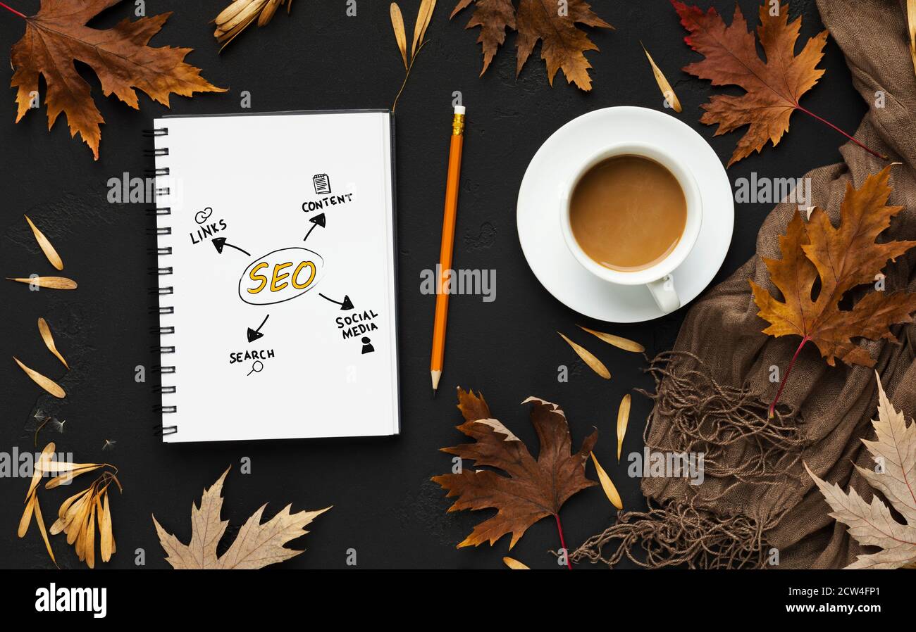 Opened Notebook With Seo Scheme Lying On Black Desk Background Stock Photo