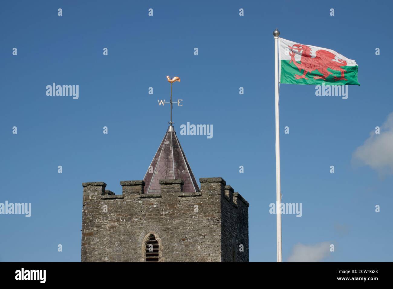 The Welsh Dragon flag flies proudly over St. Hilays Church, Llanilar, Mid Wales Stock Photo