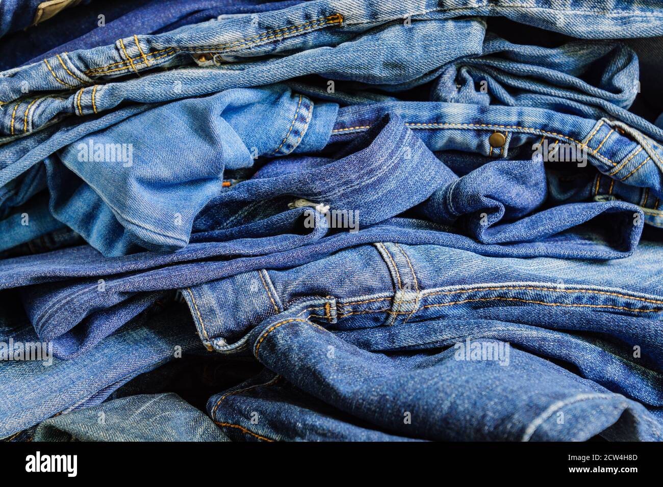 Pile of blue denim jeans. Background texture. Beauty and fashion concept  Stock Photo - Alamy