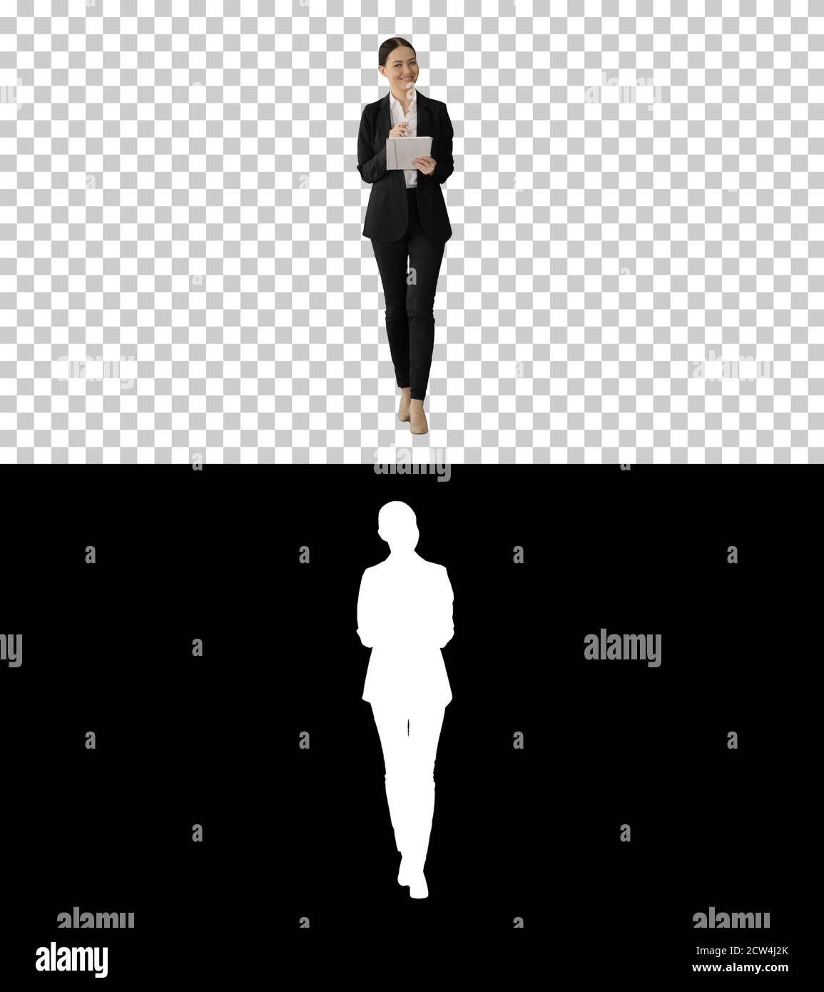 Smiling Businesswoman using computer pad while walking towards t Stock Photo