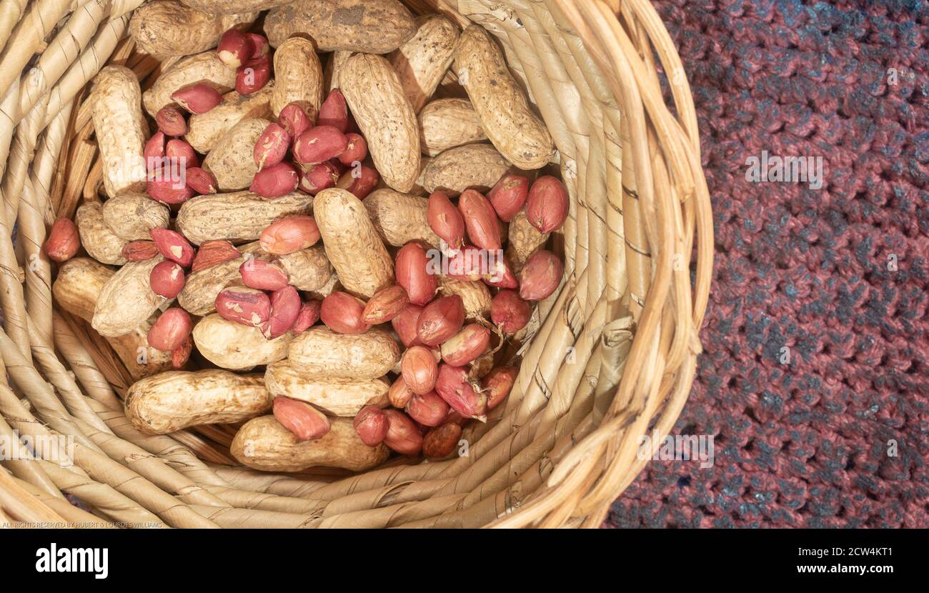 Peanuts shelled and unshelled in a basket. Stock Photo