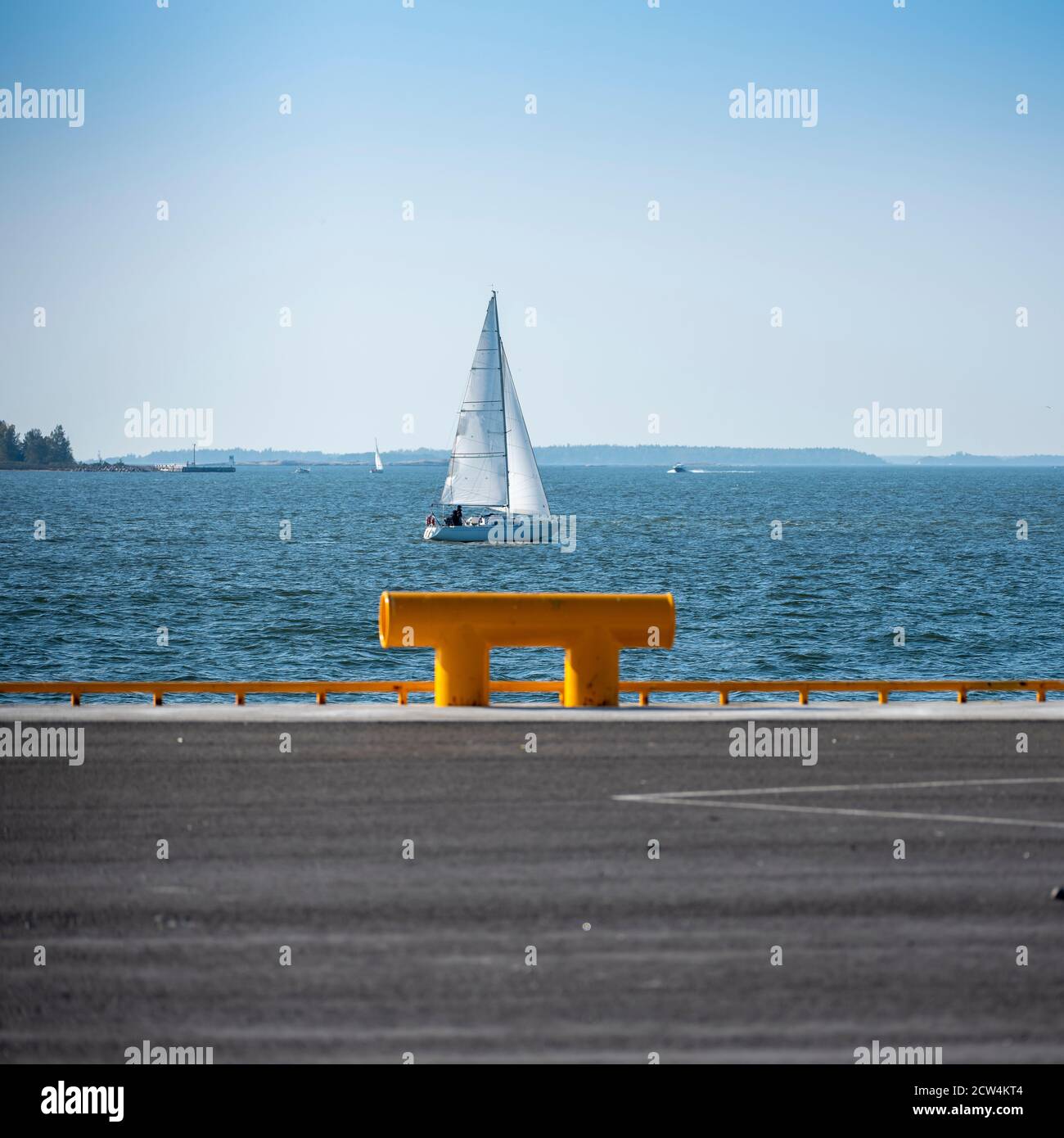 Helsinki / Finland - September 27, 2020: A sailing boat cruising on the horizon in the Finnish archipelago during a sunny and clear autumn day. Stock Photo