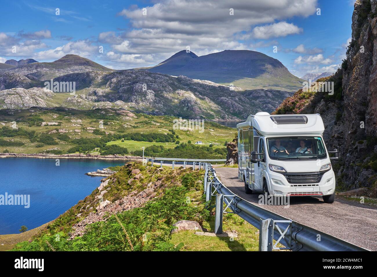 Motorhome on the North Coast 500 route on the Applecross Peninsula with Loch Shieldaig and Torridon Mountains in background Wester Ross Highlands of S Stock Photo
