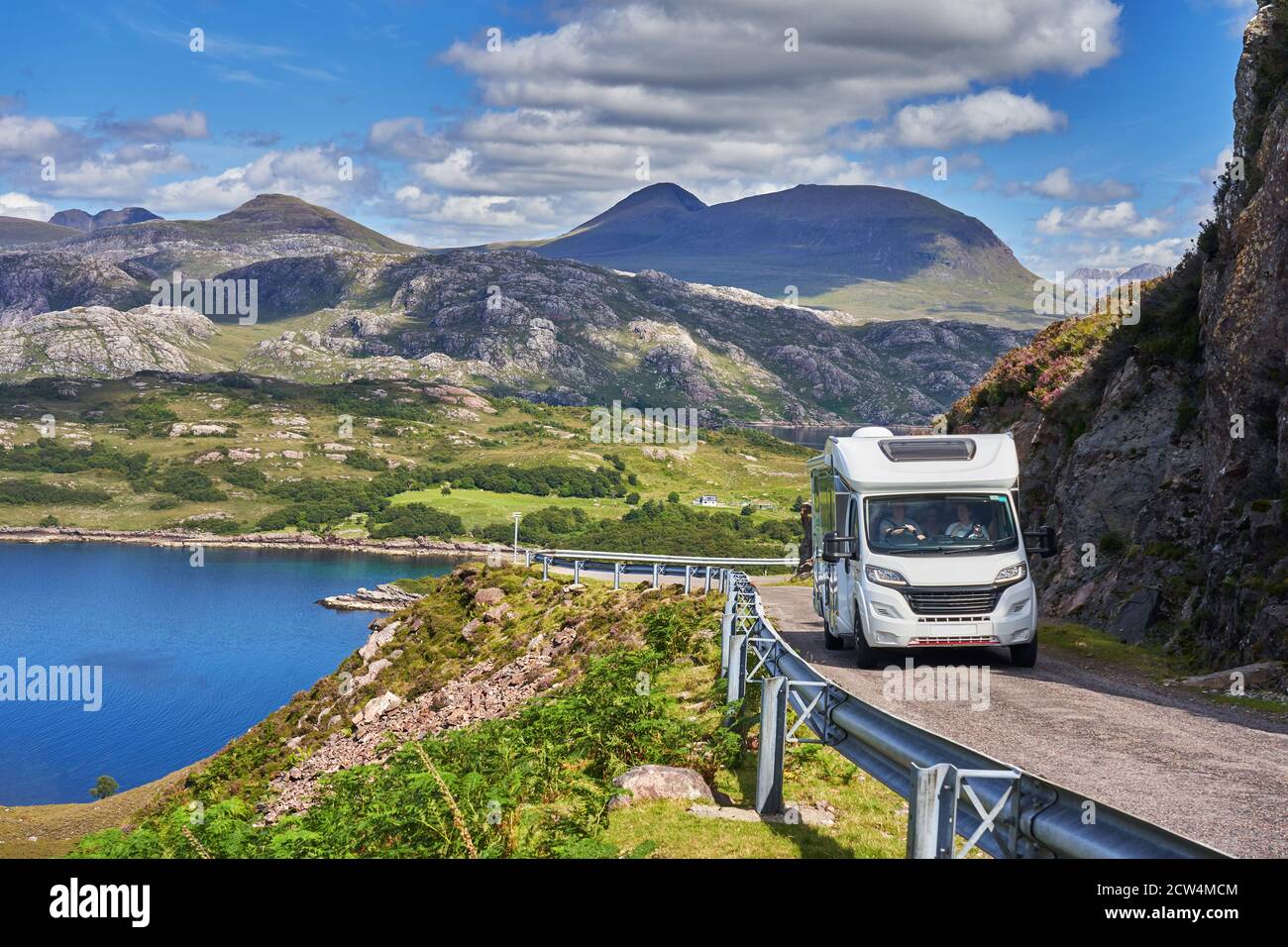 Motorhome on the North Coast 500 route on the Applecross Peninsula with Loch Shieldaig and Torridon Mountains in background Wester Ross Highlands of S Stock Photo