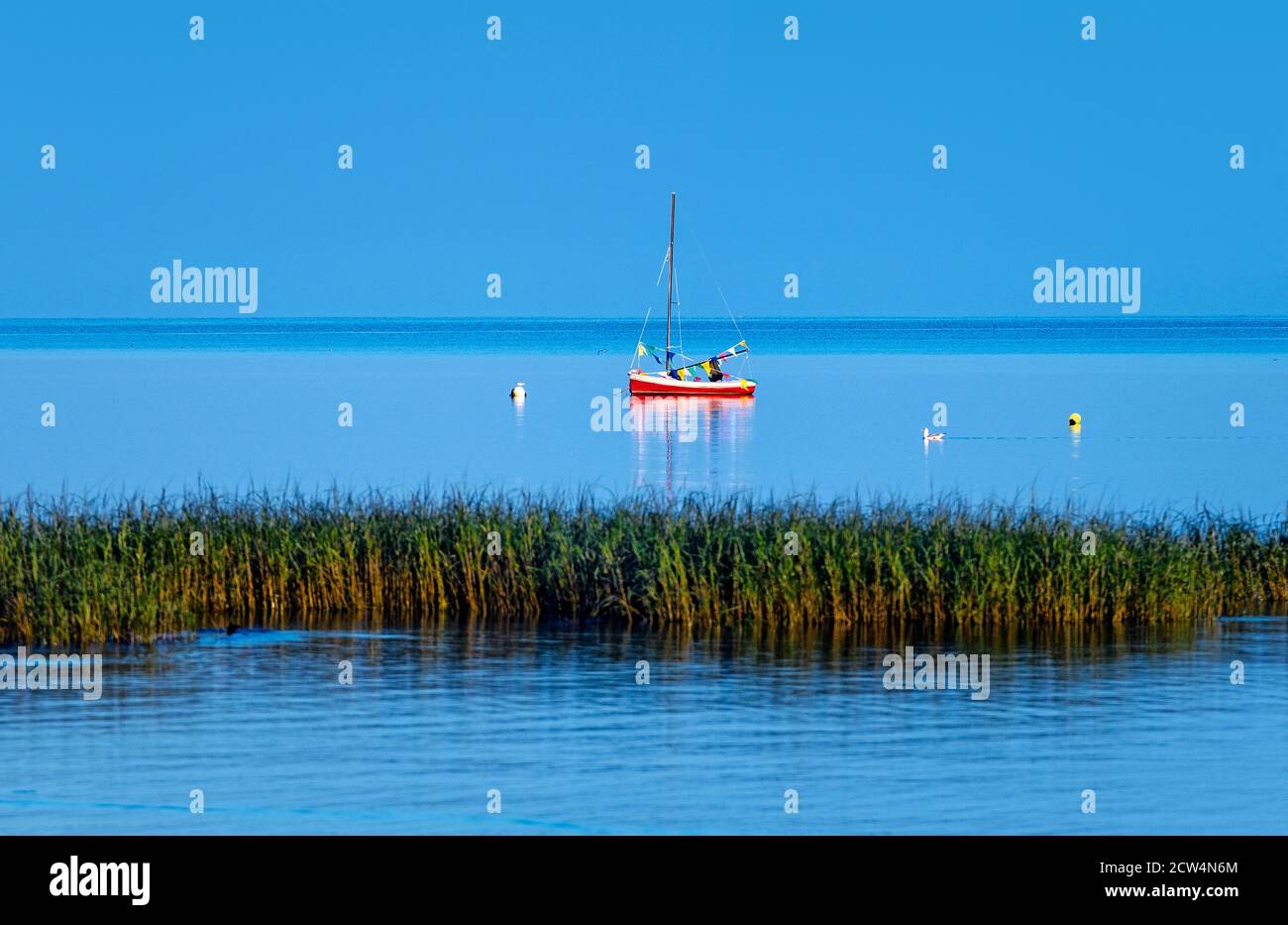 Red sailboat at Robbins Hill Beach, Brewster, Cape Cod, Massachusetts, USA. Stock Photo