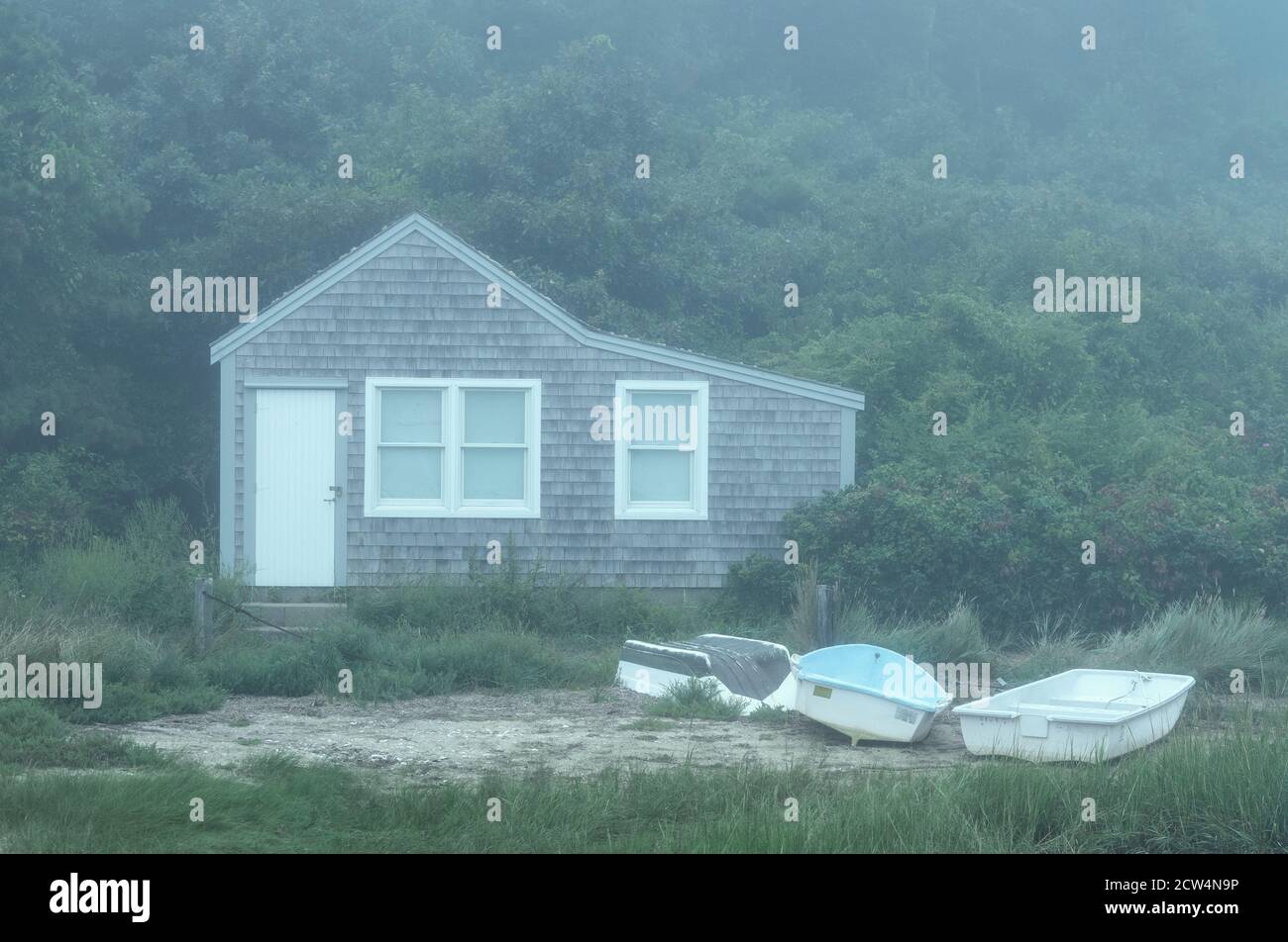 Charming fishing shack cottage in morning mist. Stock Photo
