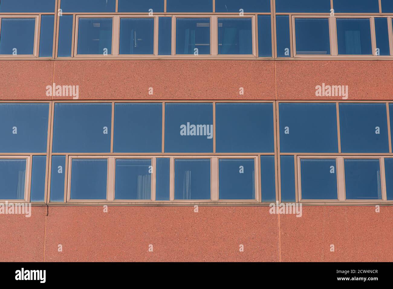 Glass facade of an abandoned office complex Stock Photo