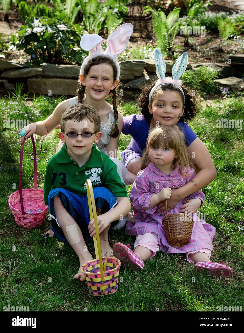 Kids pose for easter egg hunt photo. Stock Photo