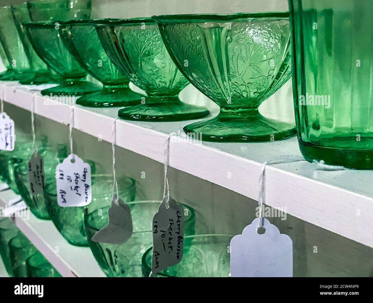 Thrift shop glassware display. Stock Photo