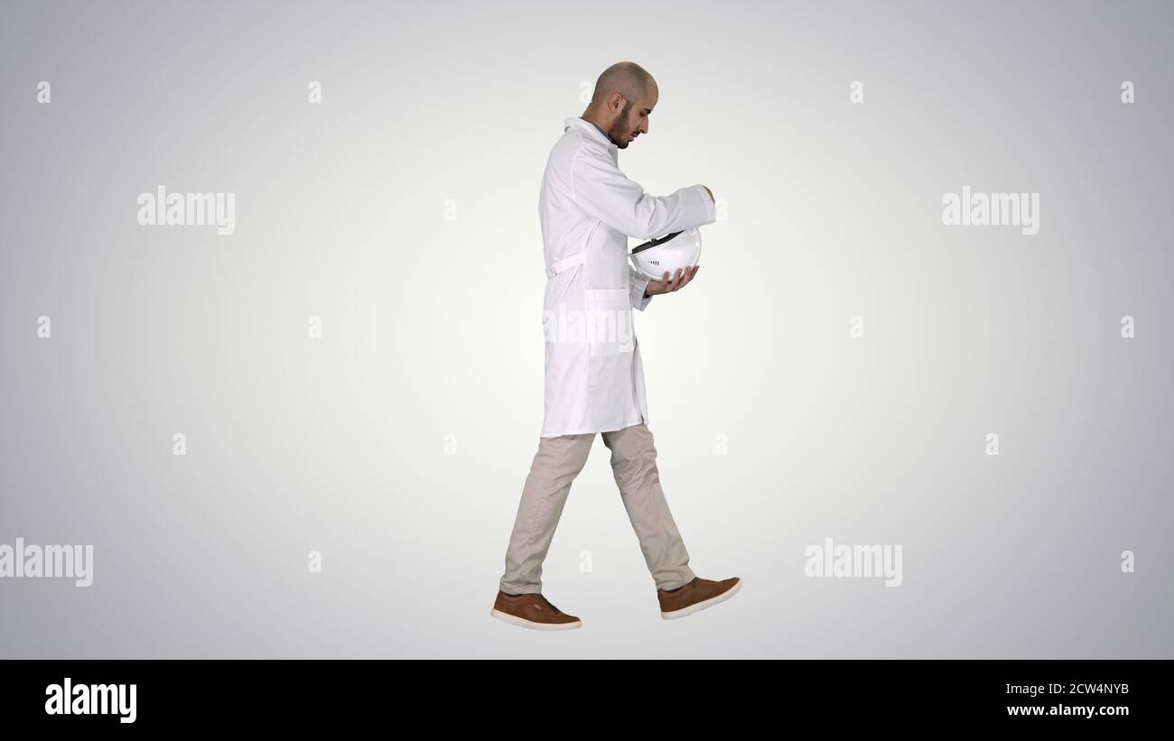 Science engineer walking and putting helmet on Safety concept on Stock Photo