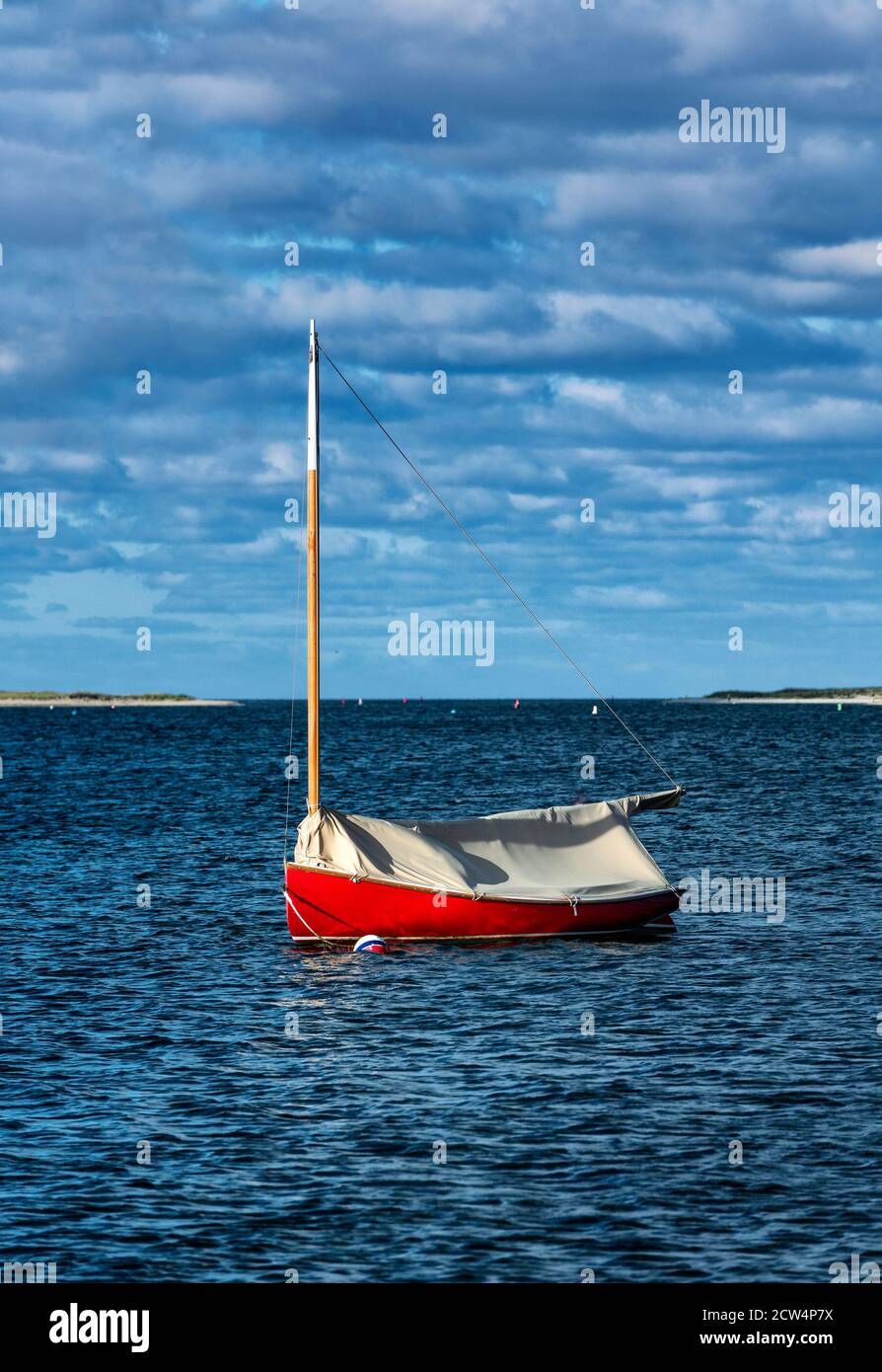 Red sailboat anchored in Chatham Harbor, Cape Cod, Massachusetts, USA. Stock Photo