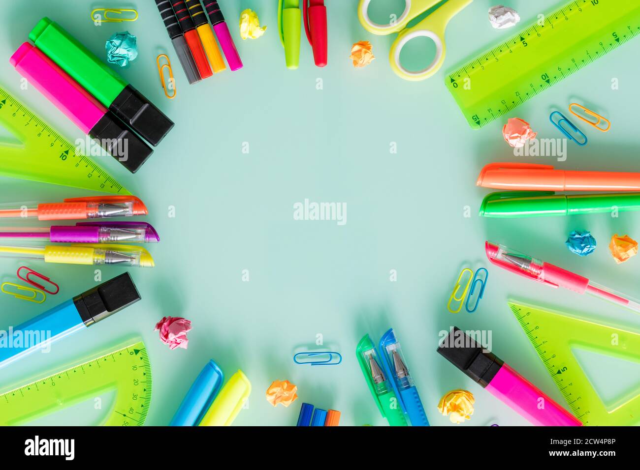 school and office items, colored pens, staples, markers, set squares, on a pastel glass. Empty space for text. Stock Photo