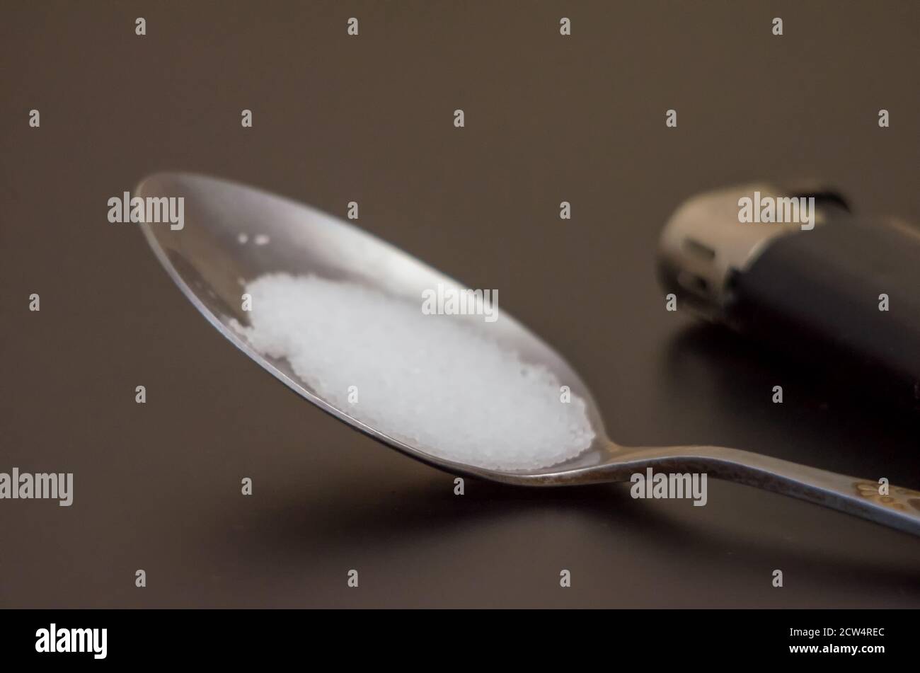 spoon with drugs for heroin cooking on dark table. Drug addiction ...