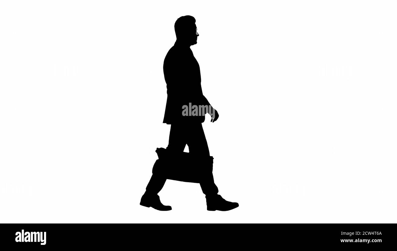 Silhouette Busy man walking on street with briefcase Stock Photo - Alamy
